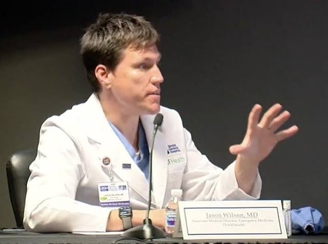 Jason W. Wilson speaking at a panel microphone